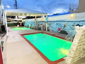 A swimming pool area with two pools, a covered seating area, and a mural depicting marine life. - Ground floor, ramp, billiards, near Playa Santa (Guanica)