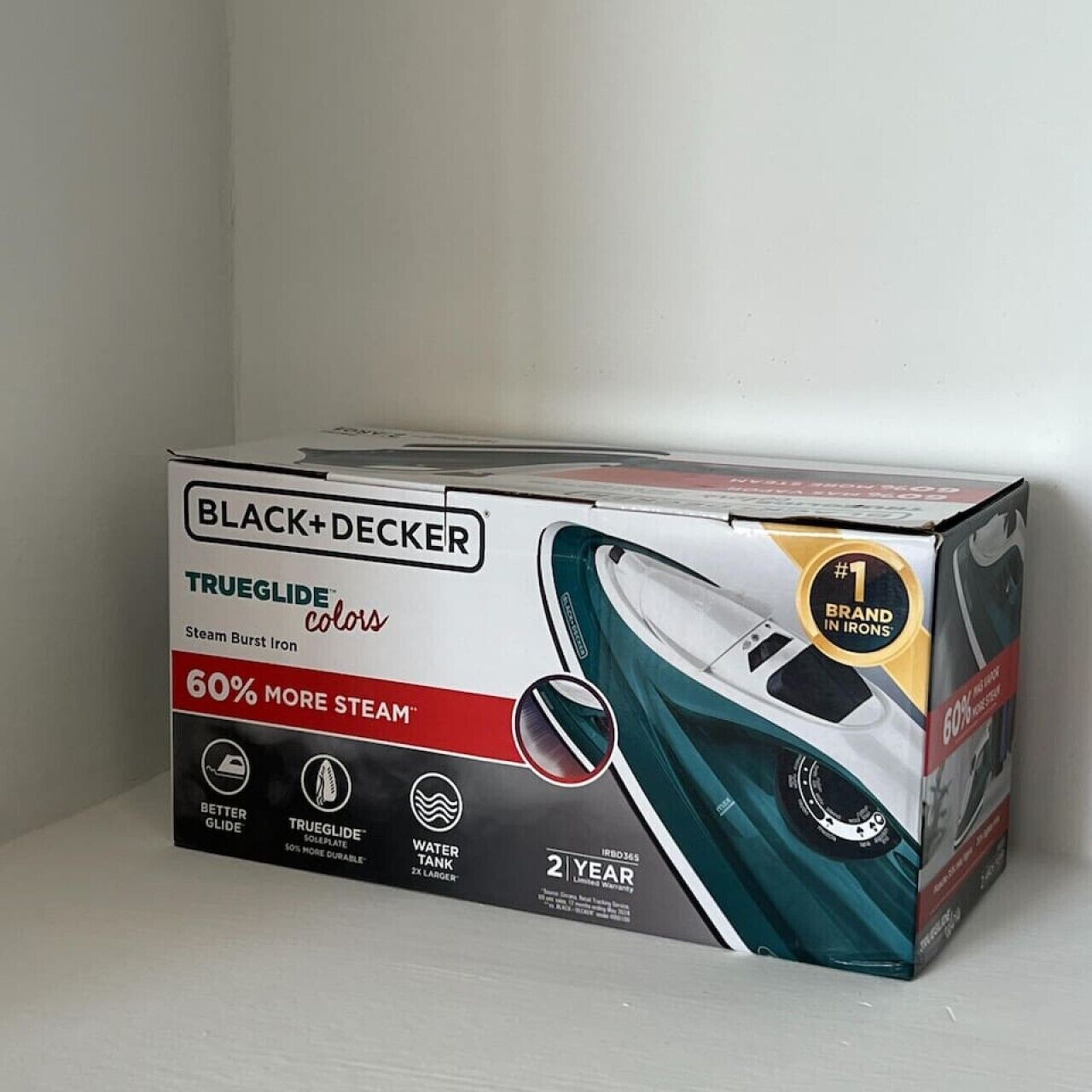 A box of Black+Decker TrueGlide color steam burst iron.