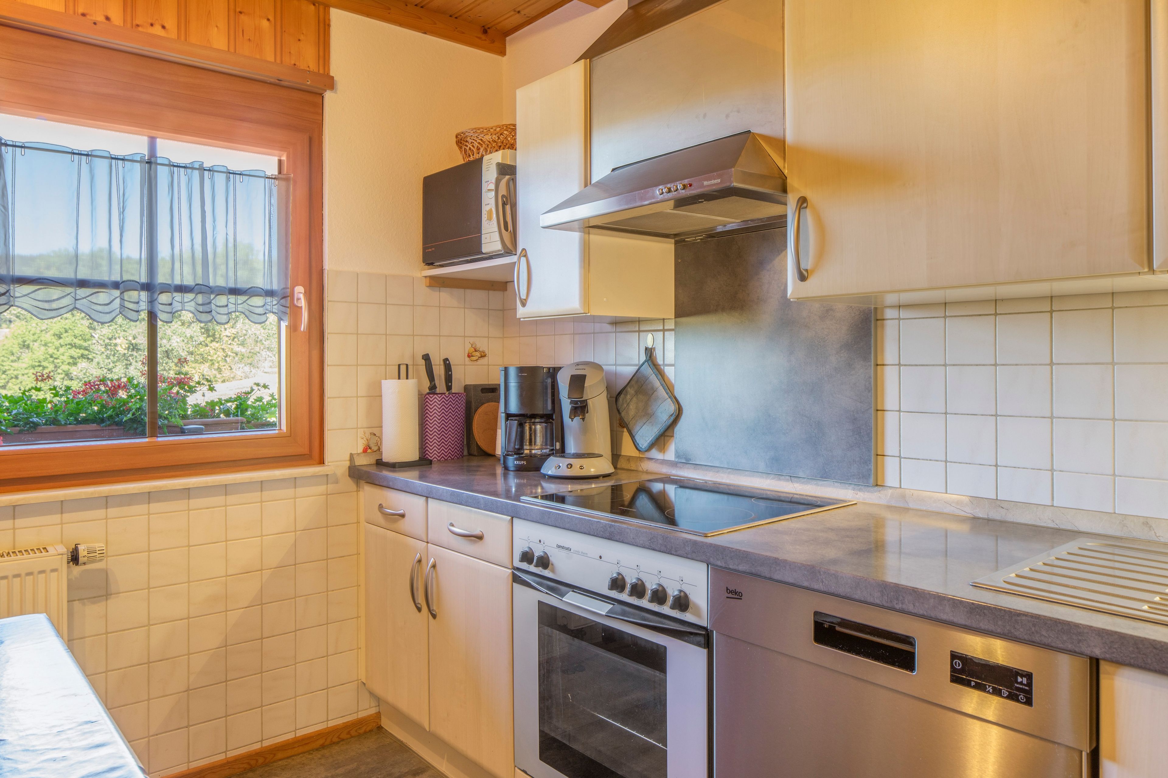 A kitchen with a built-in oven, a microwave, and a stove.