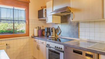 A kitchen with a built-in oven, a microwave, and a stove.