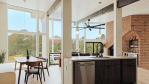 A modern kitchen with large windows, a central island, and a brick oven. - The Doeller House | Pool, Sauna & Speakeasy (Sedona)
