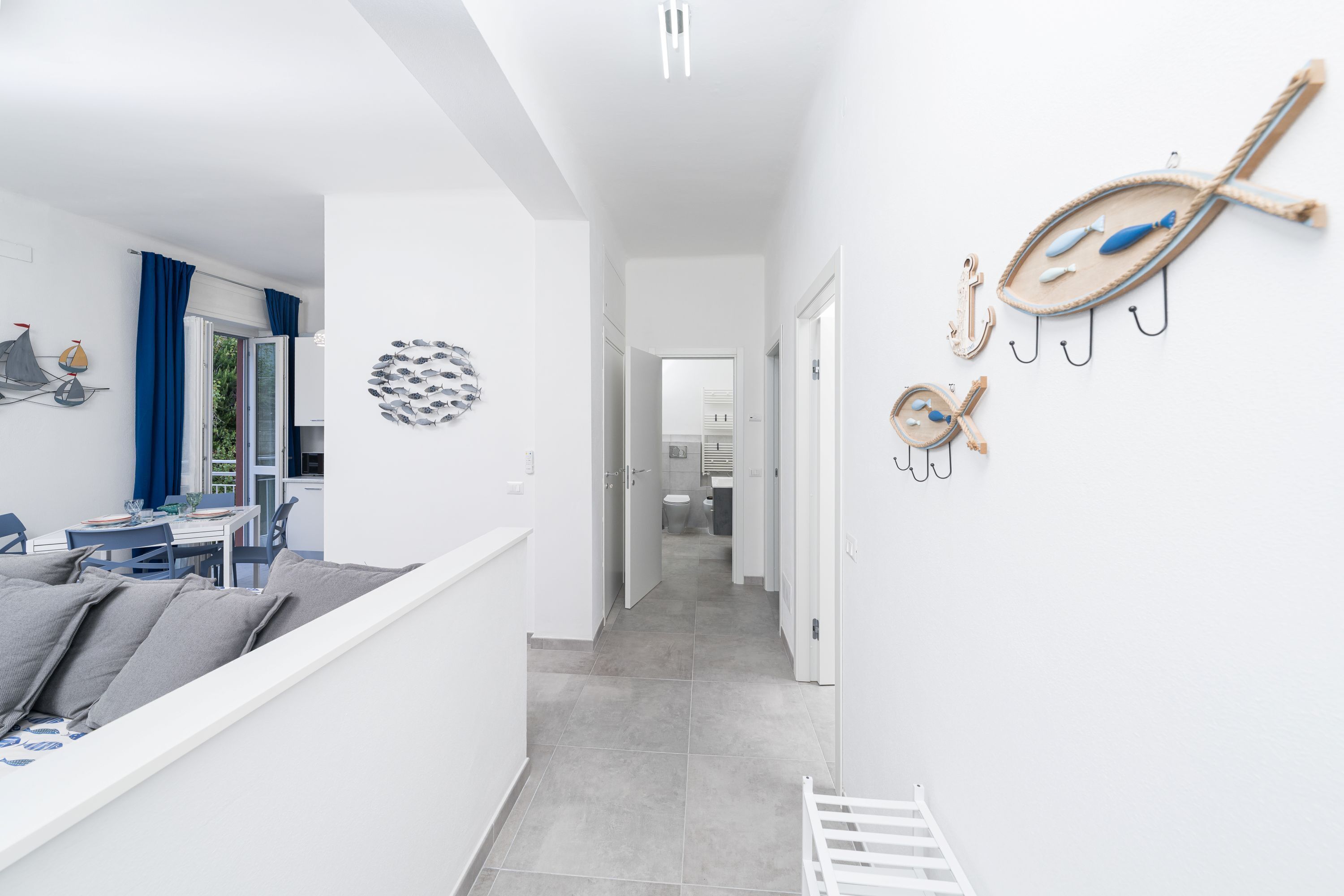 A modern interior with a dining area, a hallway, and decorative wall art.