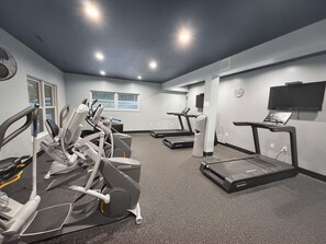 A gym with treadmills, elliptical machines, and a stationary bike. - Canopy Seven: Tree Top - Pools - Pickleball - near Golf (Lake Ozark)