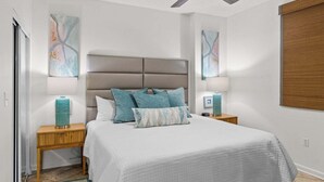 A bedroom with a bed, two bedside tables, a ceiling fan, and abstract wall art. - 805 Gulf Front Views & Rare Gulf Front Pool ~ Gorgeous 2-bdm ~ Book Sept 28th (Destin)