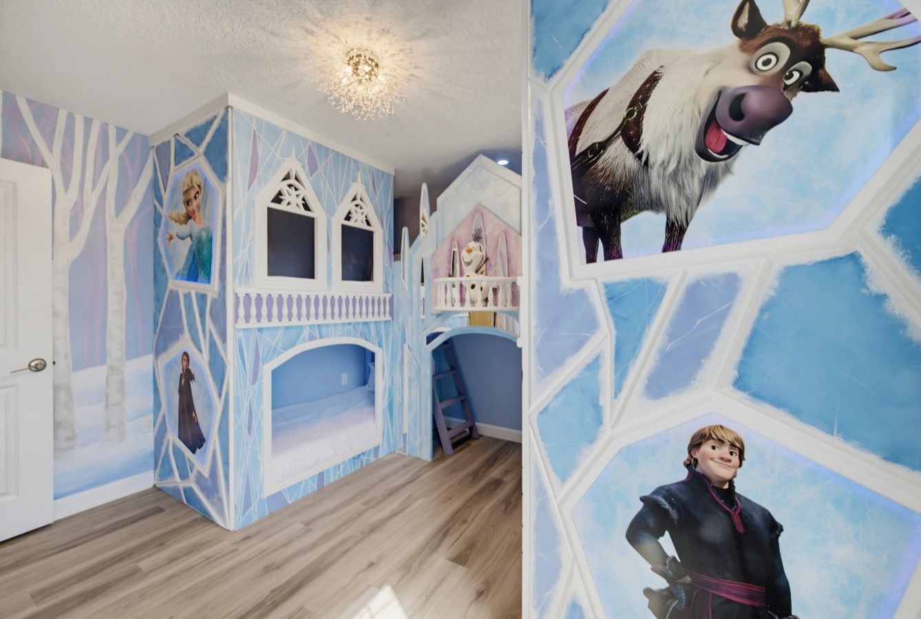 A room with a bed, a wall mural, and a door.