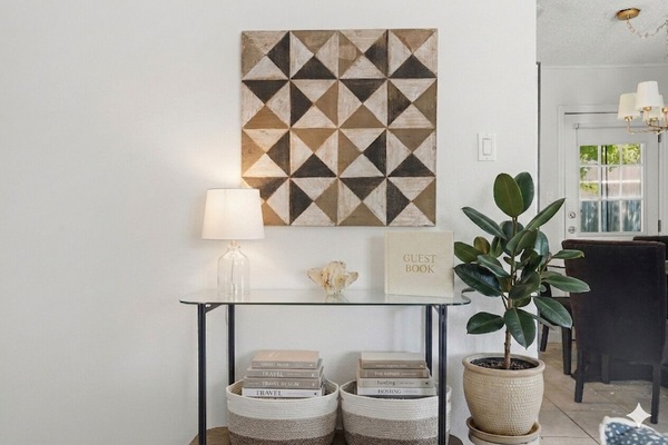 Relax in a Stylish Living Room Featuring Original Art, Local Texas Plants, Accent Tables, and Board Games