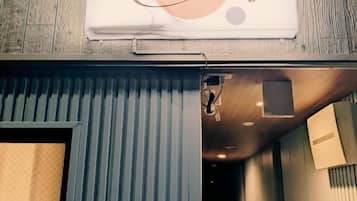 A hallway with a sign reading 'Star Minami Senju' and a door leading to a room.