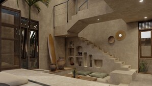 A modern interior with a staircase, seating area, and decorative elements. - Baia Villas Uluwatu (Pecatu)
