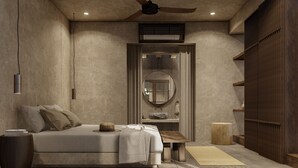 A bedroom with a bed, bedside table, nightstand, wooden headboard, ceiling fan, and a large mirror. - Baia Villas Uluwatu (Pecatu)