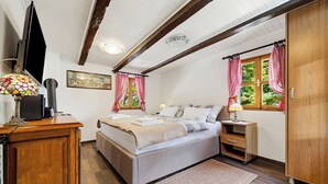 A bedroom with a bed, bedside tables, a desk, a TV, and a window with curtains. - Grandpa's House With Pool, Gornja Stubica, Croatia (Gornja Stubica)