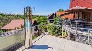 A terrace with a metal railing, a water fountain, and a view of the surrounding landscape. - Grandpa's House With Pool, Gornja Stubica, Croatia (Gornja Stubica)