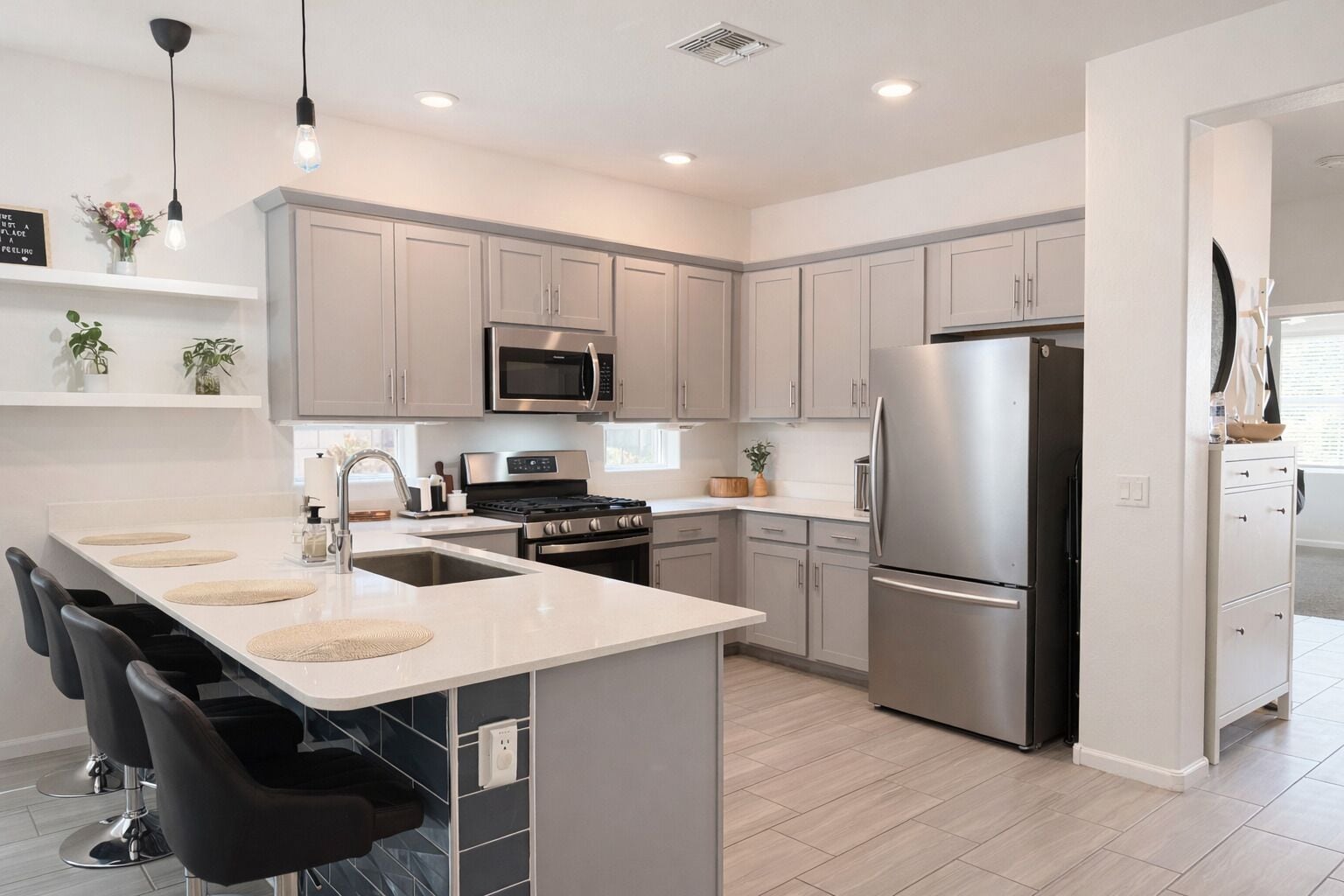 A modern kitchen with a central island, stainless steel appliances, and a minimalist design.