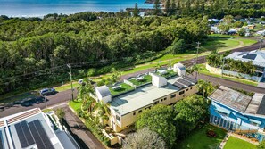 A residential area with a house featuring a green roof, solar panels, and a view of the ocean. - The Sails 1/21 Beech Street  Evans Head (Evans Head)