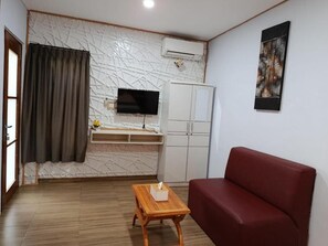 Quarto casal luxo, vista para o jardim | Área de estar