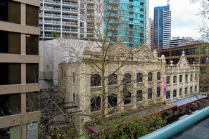 A historic building with arched windows and a central dome, surrounded by modern high-rise buildings. - Havencrest 2BR Sydney CBD | Near Darling Harbour (Sydney)