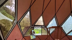 A room with a bed, a small table, and a chair. - Beautiful 2 Story Dome Perfect for Your Getaway (Rivas)