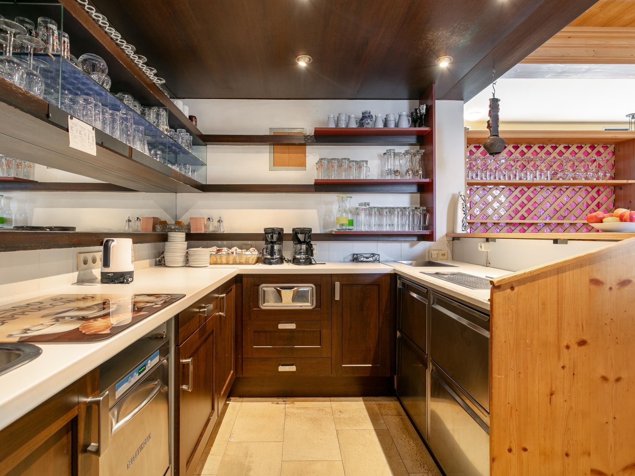 A kitchen with wooden cabinets, a countertop, and various kitchen appliances.
