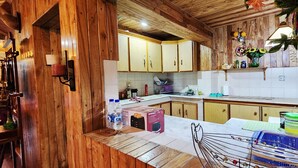 Une cuisine dotée de meubles en bois, d’un plan de travail en marbre et de divers appareils électroménagers.