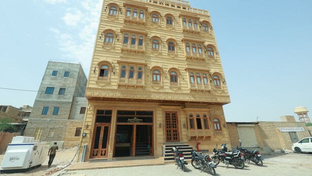 A multi-story building with a sign indicating it is a hotel. - Jigyasa palace hotel (Jaisalmer)