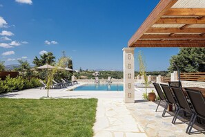 A pool area with lounge chairs, a pergola, and a view of the landscape. - New Luxurious Villa With Stunning Pool,views &bbq! (Rethymno)