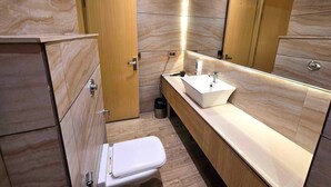A modern bathroom with a toilet, sink, and mirror. - Townhouse Rambagh Amritsar (Amritsar)