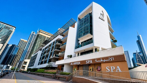 A modern building with a spa, multiple floors, and a prominent sign. - HAVN - 1 Bedroom in Azure, 5 mins to DMCC metro (Dubai)