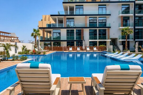 Outdoor pool - HAVN - Studio in Oxford 212, JVC (Dubai)