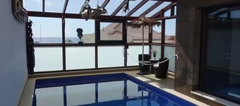 Designer home with a heated (covered) pool