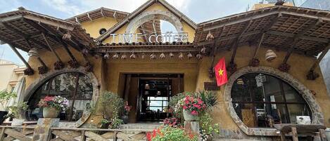 A building with a sign reading 'TIME coffee' and a red flag.