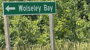 A directional sign for Wolsley Bay.