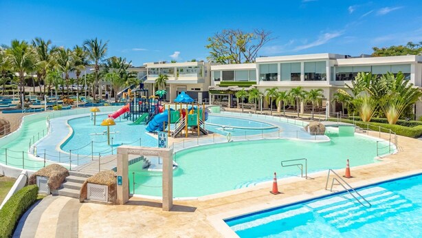 A resort pool area with multiple water slides and a separate swimming pool. - Luxe Villa in the Caribbean • Gated • Pool & Sun (Sosúa)
