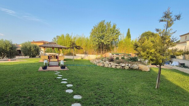 A well-maintained garden with a gazebo, stone pathway, and various trees. - A charming 32 m² studio apartment with an adjoining terrace. (Les Pennes-Mirabeau)