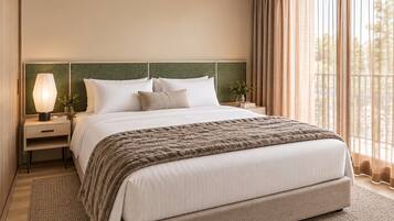 A neatly made bed with a fluffy blanket, a bedside lamp, and a nightstand with a vase of flowers.