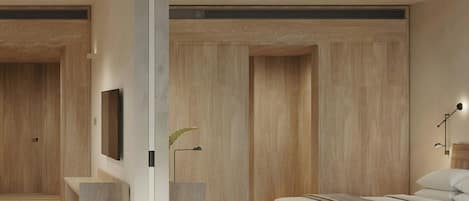 Un dormitorio moderno con cama, televisor de pantalla plana y mesita de noche.