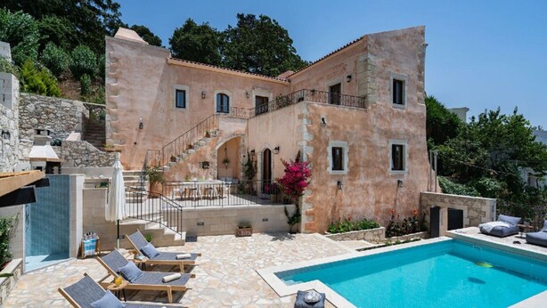 A villa with a swimming pool, outdoor seating, and a staircase leading to the upper floor. - 3-bed Armeni Mountain Oasis (Rethymno)