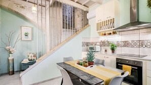 A modern kitchen with a dining area, a staircase, and a view of the living room. - 3-bed Armeni Mountain Oasis (Rethymno)