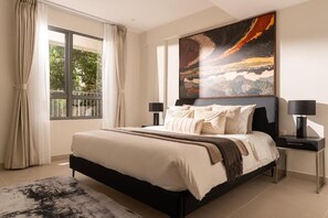 A bedroom with a large bed, two bedside tables, a window with curtains, and a painting on the wall. - Masteri Thao Dien Apartment Raymond Holm (An Khanh)