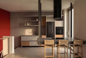 A modern kitchen with a black refrigerator, wooden cabinets, and a large window. - Serenity Villa, Anzo Villas (Thira - Santorini)