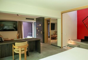 A modern living room with a flat-screen TV, a wooden bar, and a comfortable seating area. - Serenity Villa, Anzo Villas (Thira - Santorini)