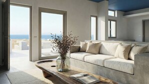 Una sala de estar moderna con un sofá, una mesa de centro de madera y vistas al océano.
