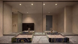A modern bathroom with a large mirror, two sinks, and a door. - Dreamscape Villa, Anzo Villas (Thira - Santorini)