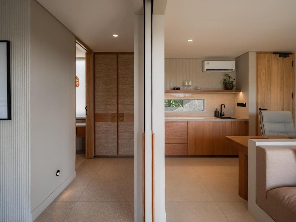 A modern kitchen with wooden cabinets, a built-in oven, and a countertop.