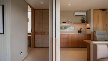 A modern kitchen with wooden cabinets, a built-in oven, and a countertop.