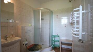 Ein Badezimmer mit Waschbecken, Toilette, Dusche und Handtuchhalter.