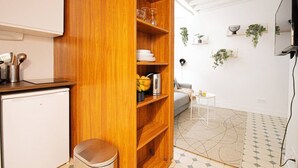 A compact kitchen with wooden shelves, a small fridge, and a coffee machine. - 21-Studio for 2 People-Central-Le Marais-Paris 4th (Paris)