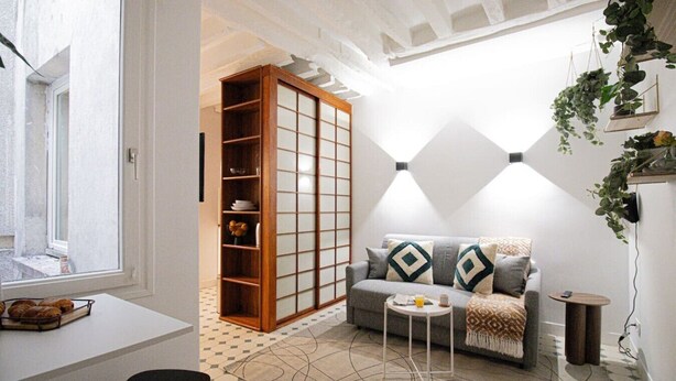 A living room with a sofa, a small table, a cabinet with glass doors, and a patterned floor. - 21-Studio for 2 People-Central-Le Marais-Paris 4th (Paris)