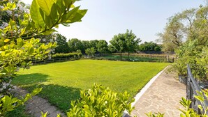Un jardí ben cuidat amb un camí de pedra i una tanca de fusta.
