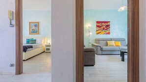 A room with a bed, a sofa, a table, and a painting on the wall. - Regina Margherita by Wonderful Italy (Torino)