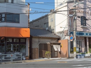 A street view with buildings, a no parking sign, and a pedestrian crossing.