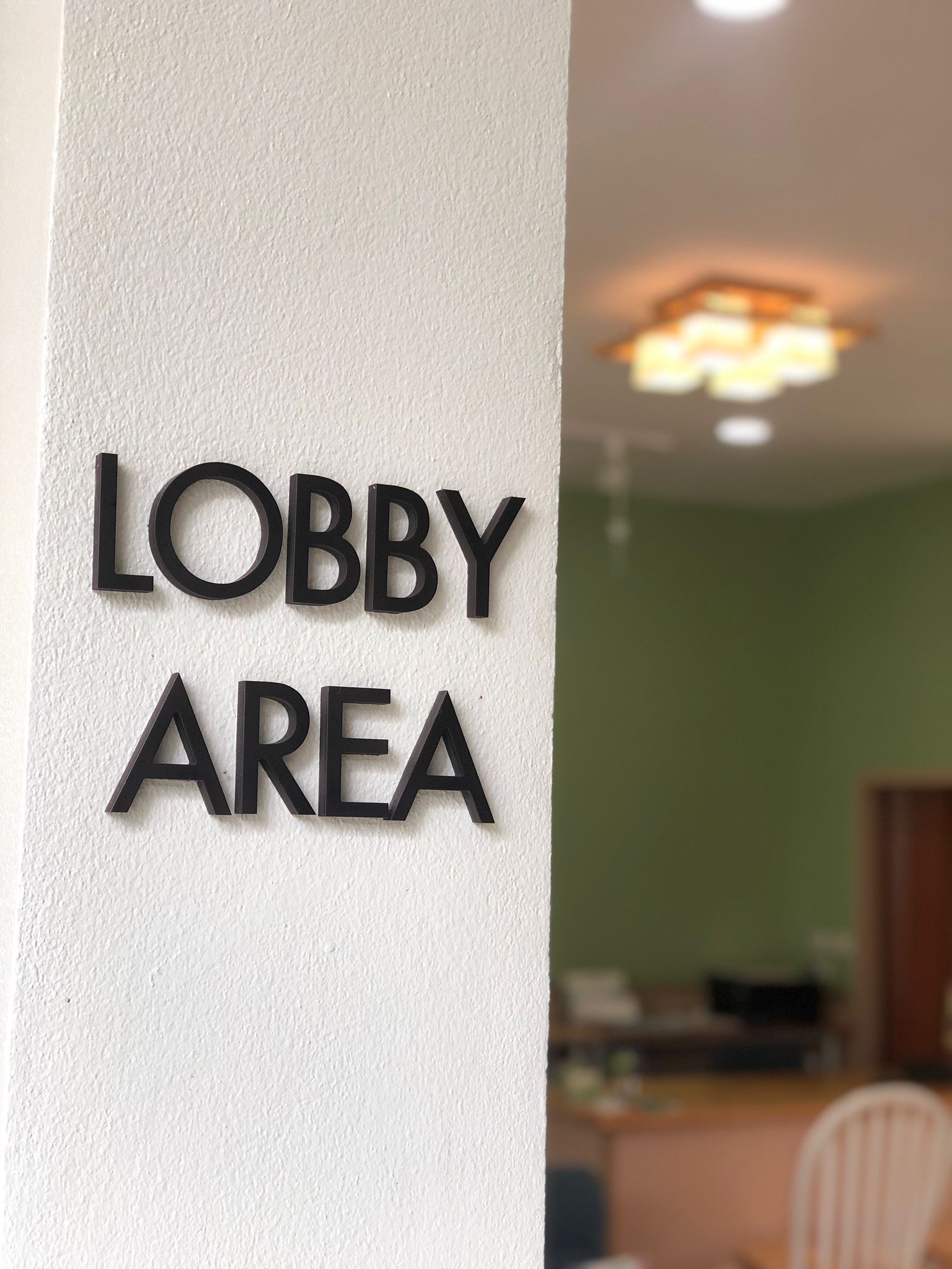 A wall sign indicating a lobby area.